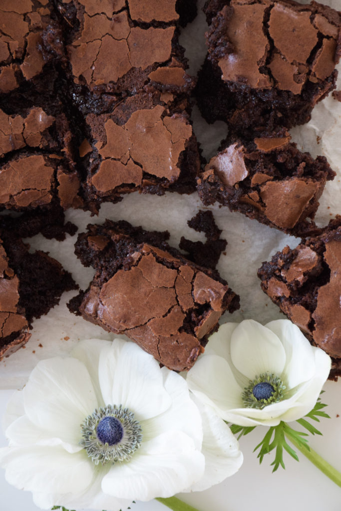 Brownies with crinkle tops on parchment paper