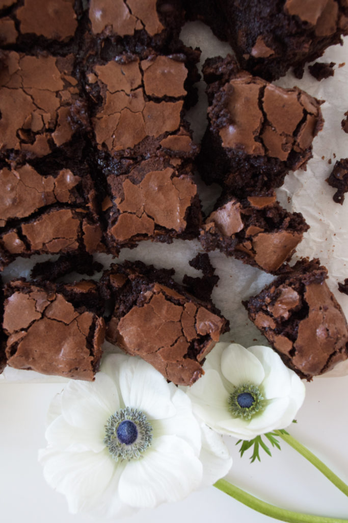 Brownies with crinkle tops on parchment paper